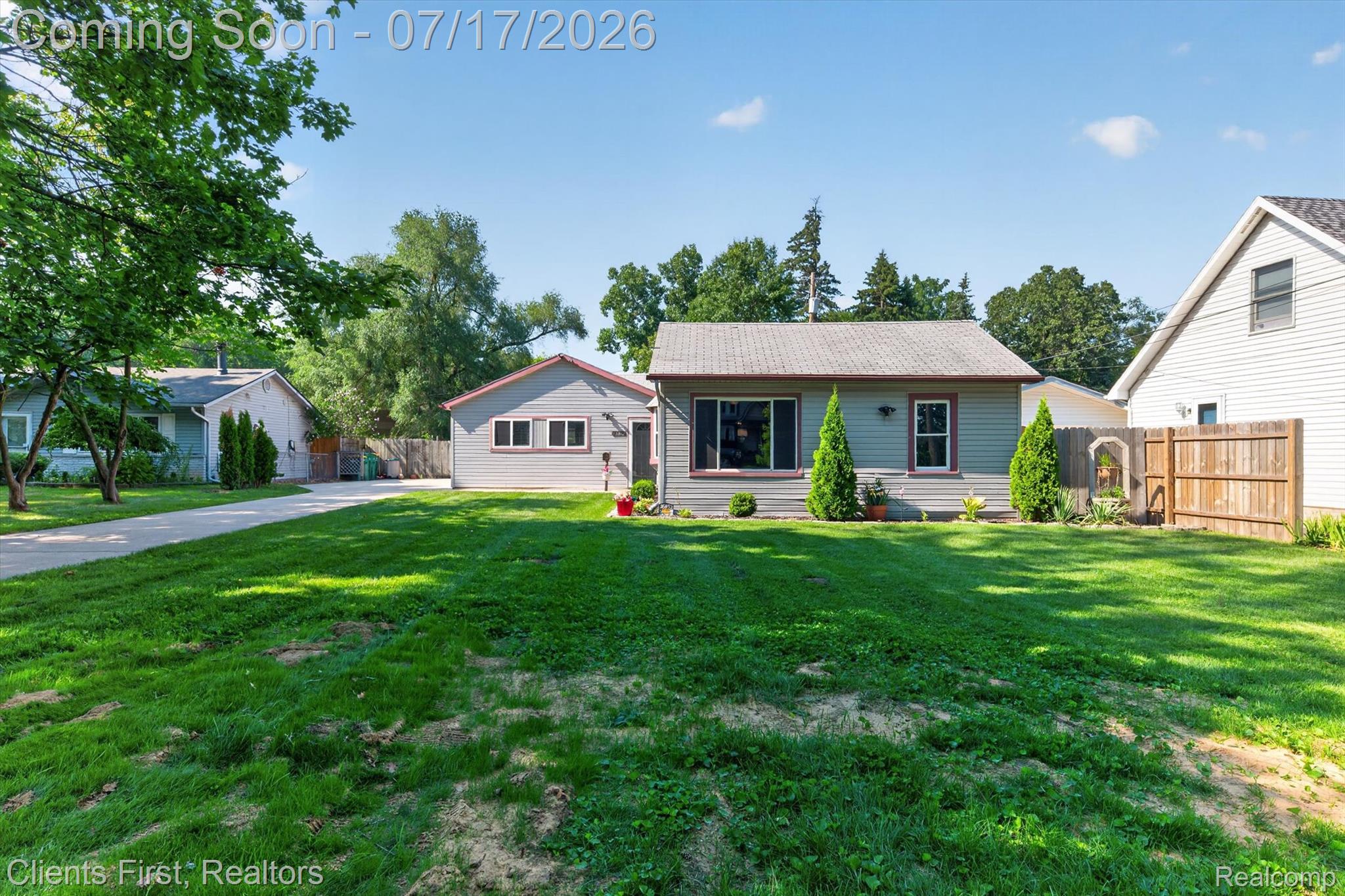 36852 Chase Street Romulus, MI 48174 - Photo 39 of 40 Expansive front lawn with a single-story residence featuring light blue siding and a dark roof
