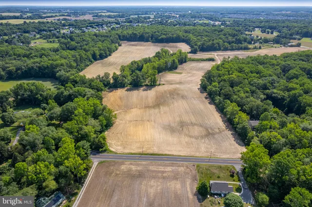 an aerial view of a house with a garden and lake view