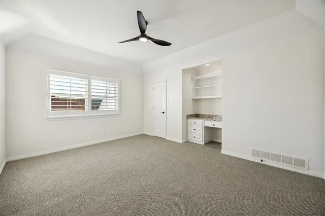 an empty room with a empty space and windows