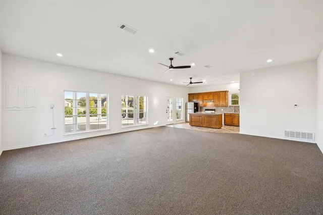 a view of a livingroom with an empty space and a window