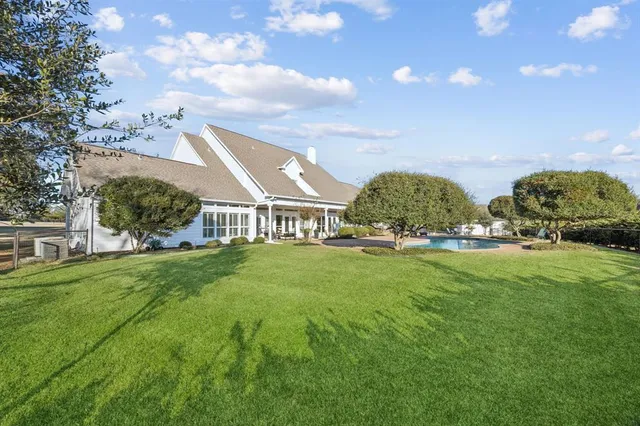 a view of house with garden space and trees