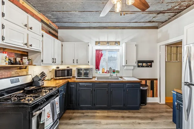 a kitchen with stainless steel appliances granite countertop a stove a sink dishwasher and a refrigerator