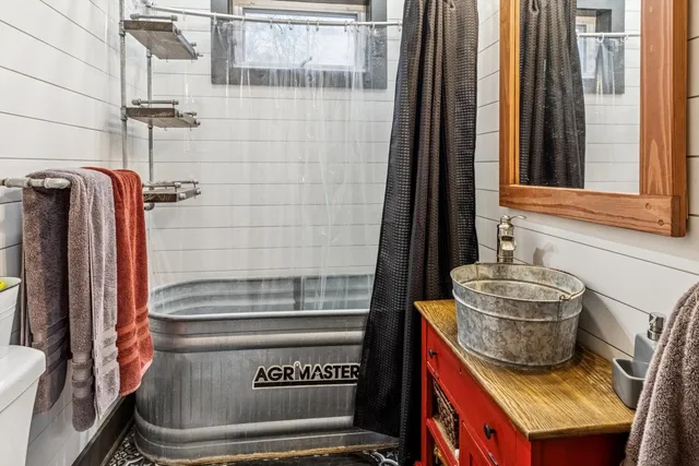 a bathroom with a toilet and shower