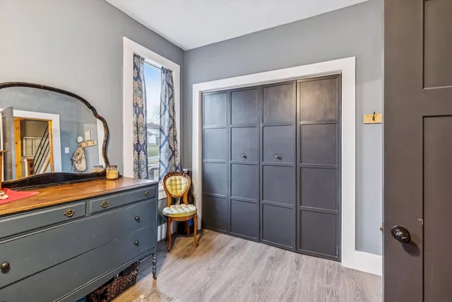 a bathroom with a sink a light fixture and a mirror
