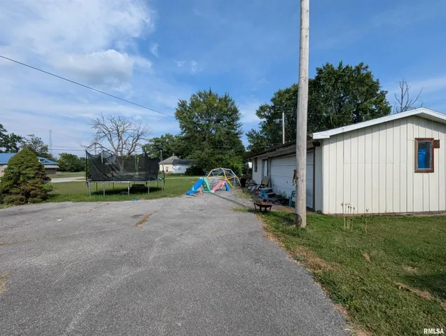 a backyard of a house with plants and trees