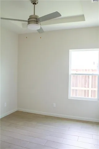 a view of a small space with wooden floor and a window