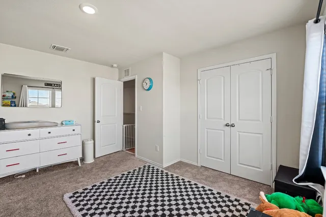 a room view with a dresser and a window