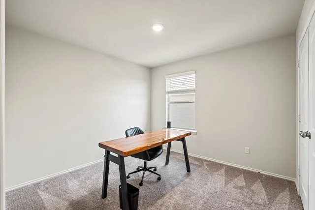 a view of a workspace with furniture