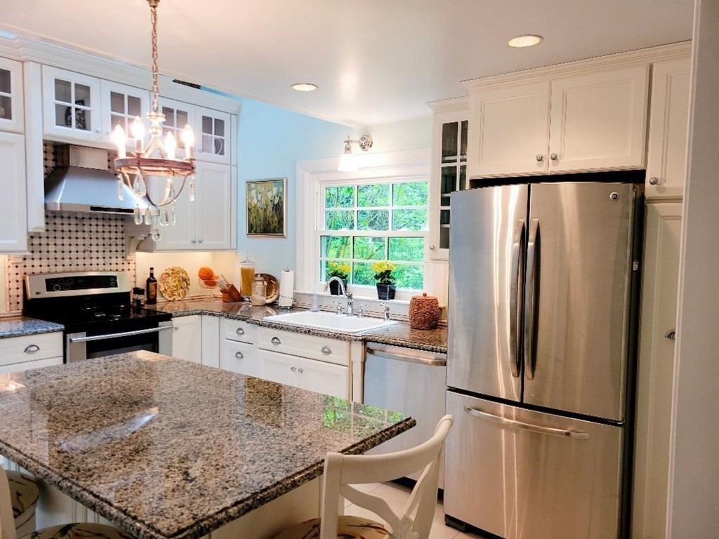 61 Gibson Road Ashburnham, MA 01430 - Photo 4 of 28 a kitchen with stainless steel appliances granite countertop a refrigerator stove microwave and sink