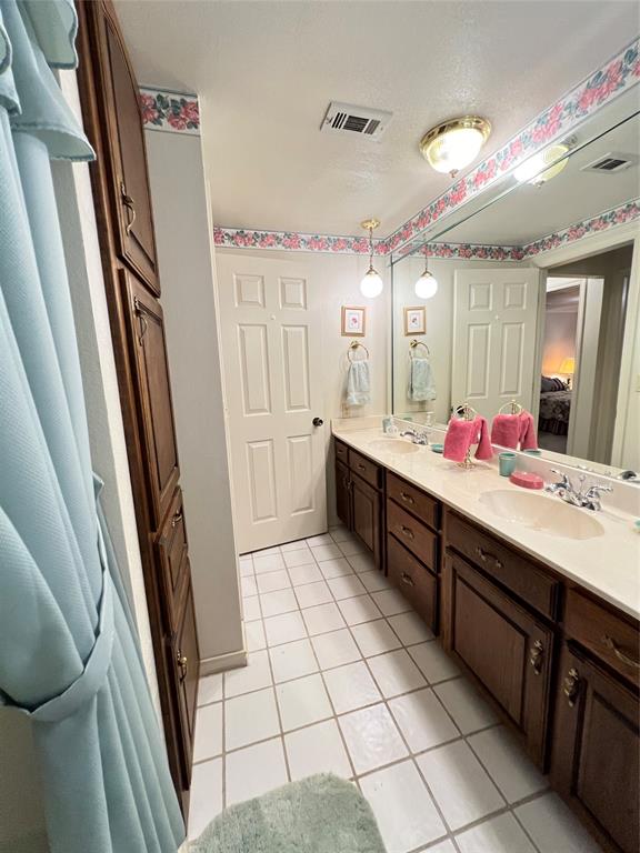 104 East Little Street Hamilton, TX 76531 - Photo 27 of 27 a spacious bathroom with a double vanity sink mirror and bathtub