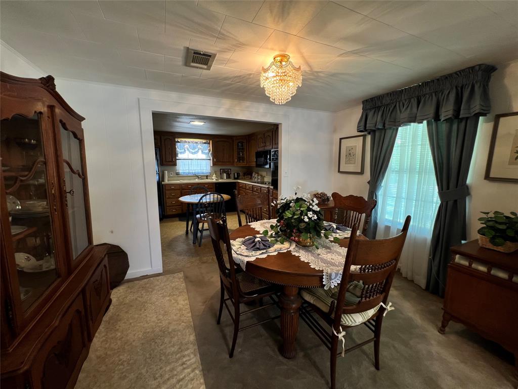 104 East Little Street Hamilton, TX 76531 - Photo 8 of 27 a view of a dining room with furniture and chandelier