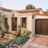 a view of a house with potted plants
