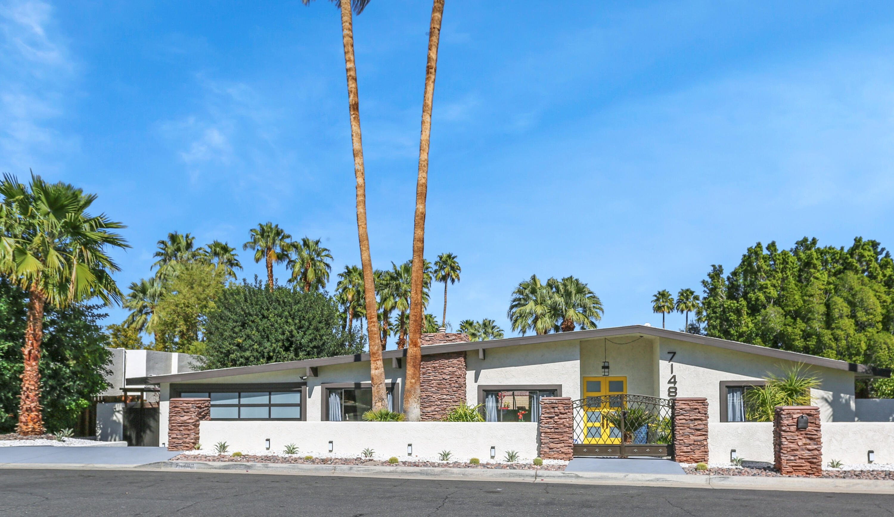 a front view of a house with a garden