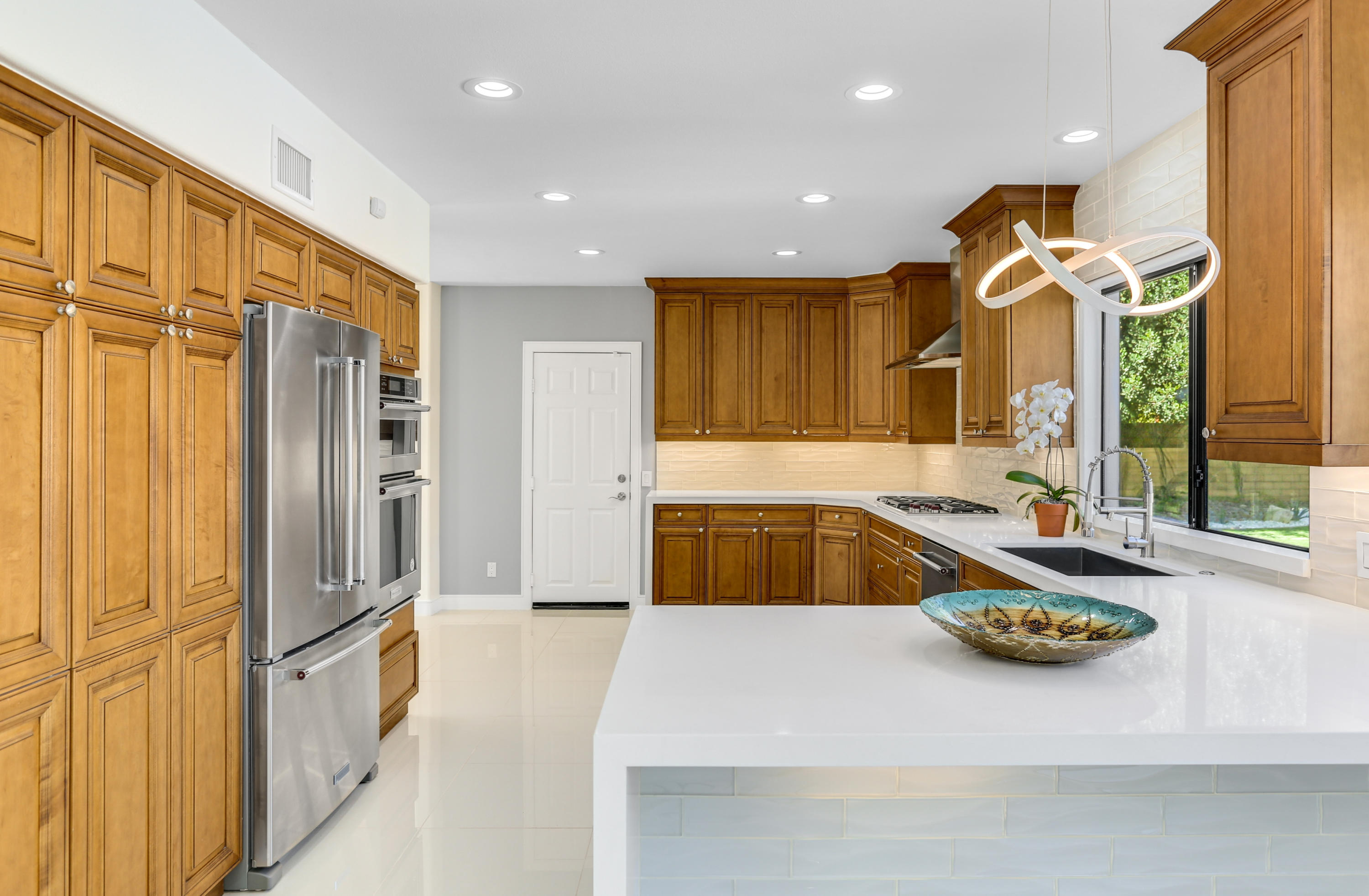 71480 Halgar Road Rancho Mirage, CA 92270 - Photo 13 of 52 a kitchen with sink refrigerator and microwave