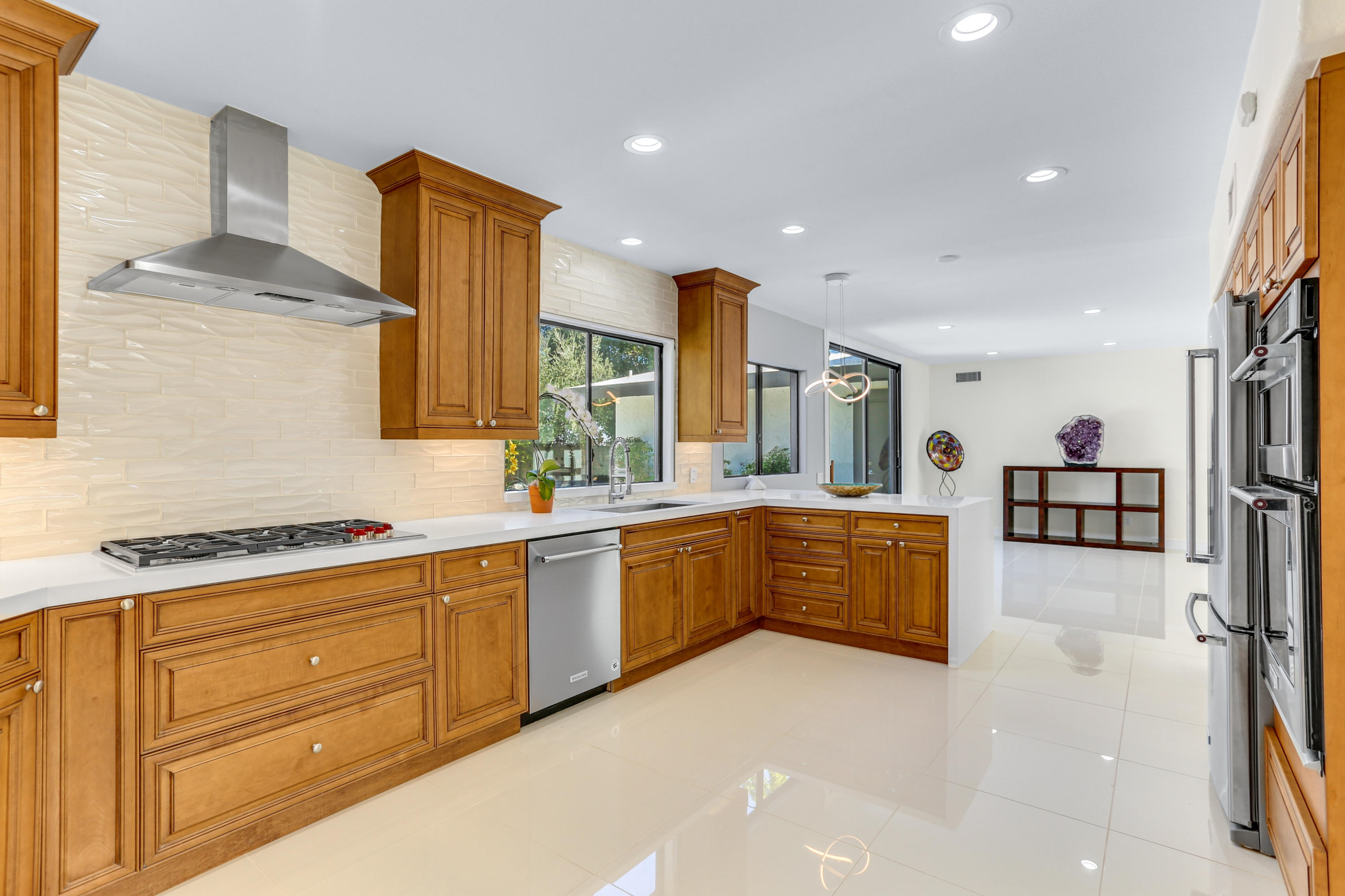 71480 Halgar Road Rancho Mirage, CA 92270 - Photo 14 of 52 a large kitchen with granite countertop a sink and white cabinets