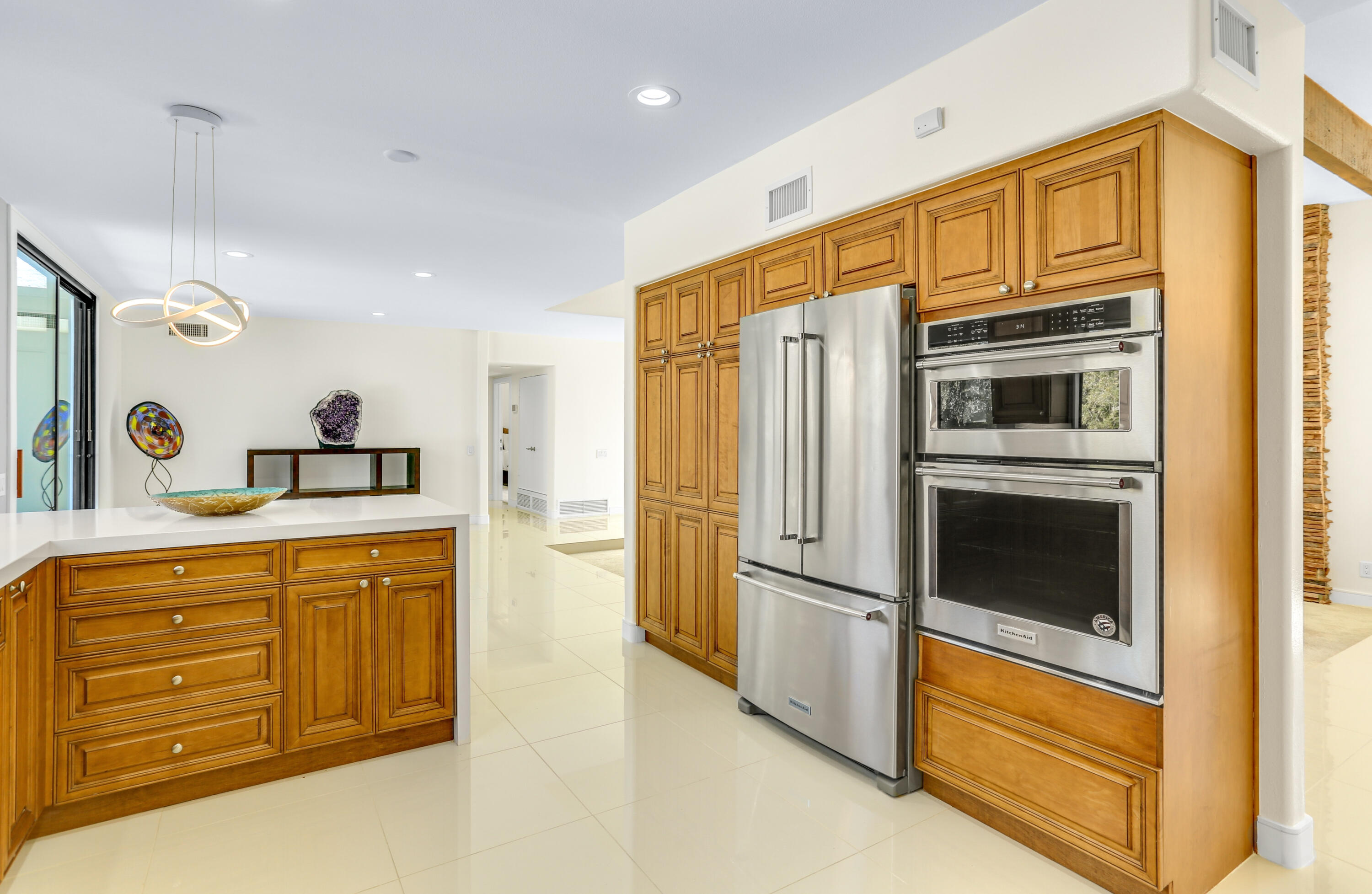 71480 Halgar Road Rancho Mirage, CA 92270 - Photo 15 of 52 a kitchen with stainless steel appliances granite countertop a refrigerator and a stove top oven