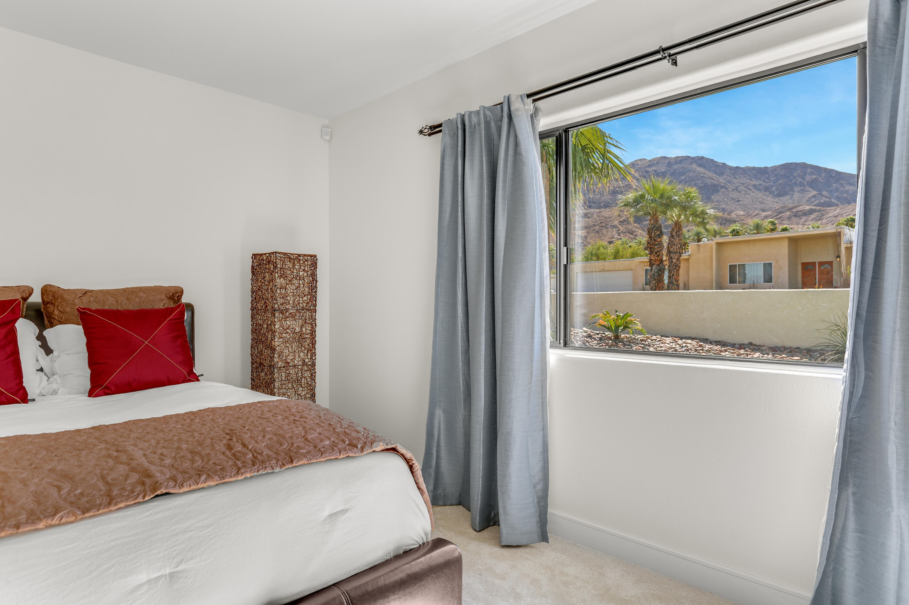 71480 Halgar Road Rancho Mirage, CA 92270 - Photo 17 of 52 a bedroom with a large bed and a window