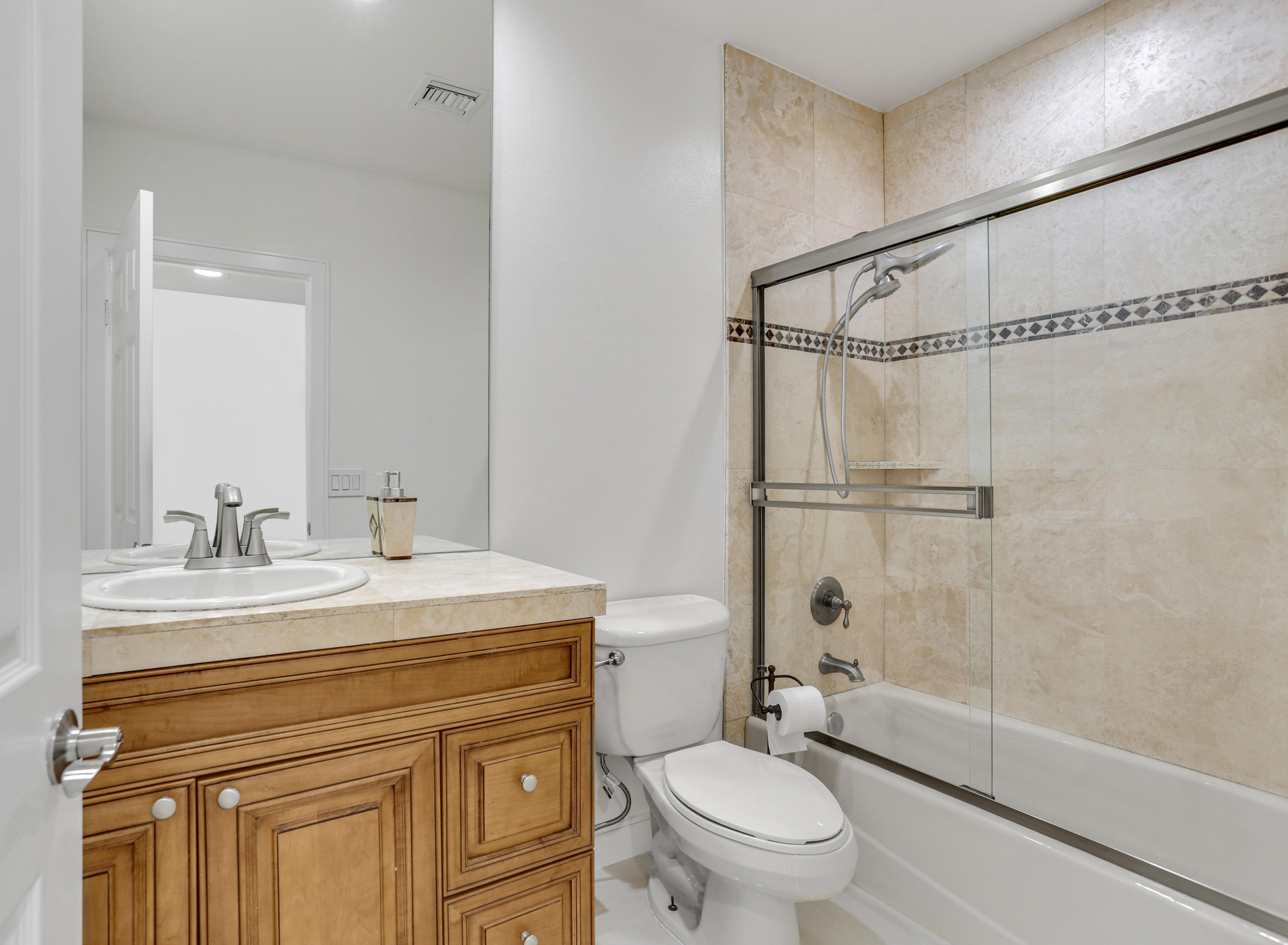 71480 Halgar Road Rancho Mirage, CA 92270 - Photo 21 of 52 a bathroom with a granite countertop sink toilet mirror and shower