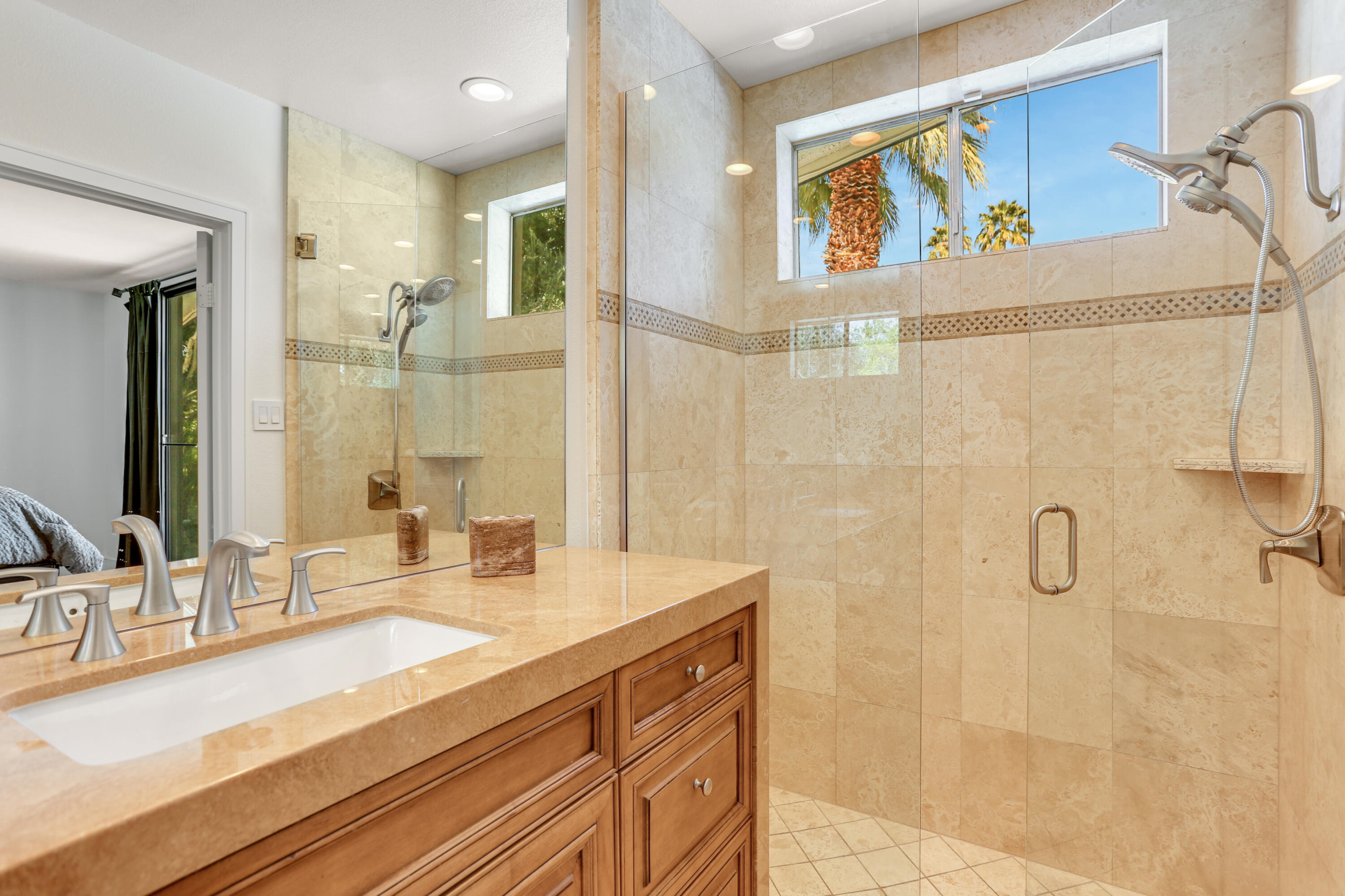 71480 Halgar Road Rancho Mirage, CA 92270 - Photo 24 of 52 a bathroom with a granite countertop sink a mirror a vanity and shower