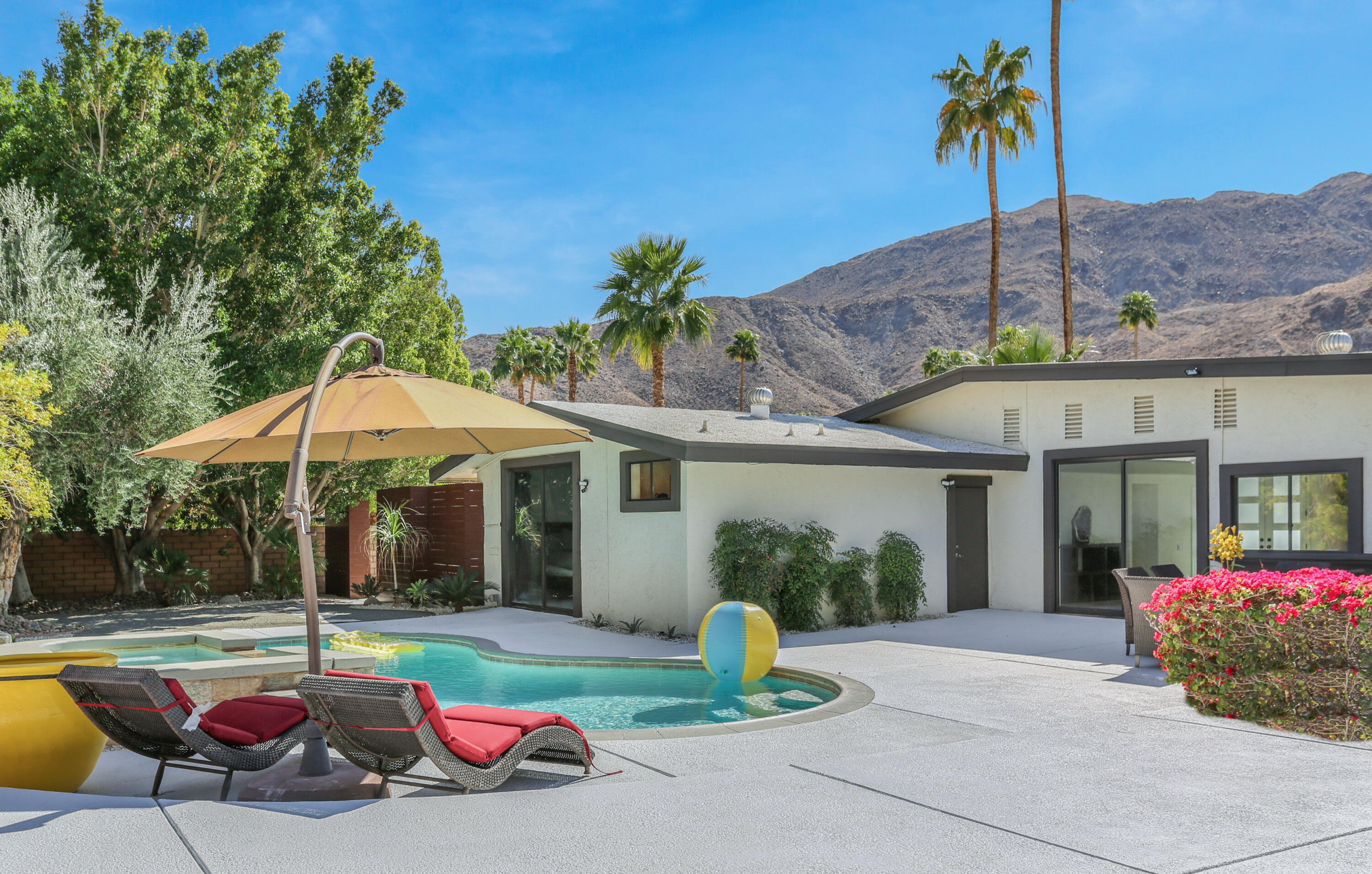 71480 Halgar Road Rancho Mirage, CA 92270 - Photo 33 of 52 a patio with a table and chairs under an umbrella