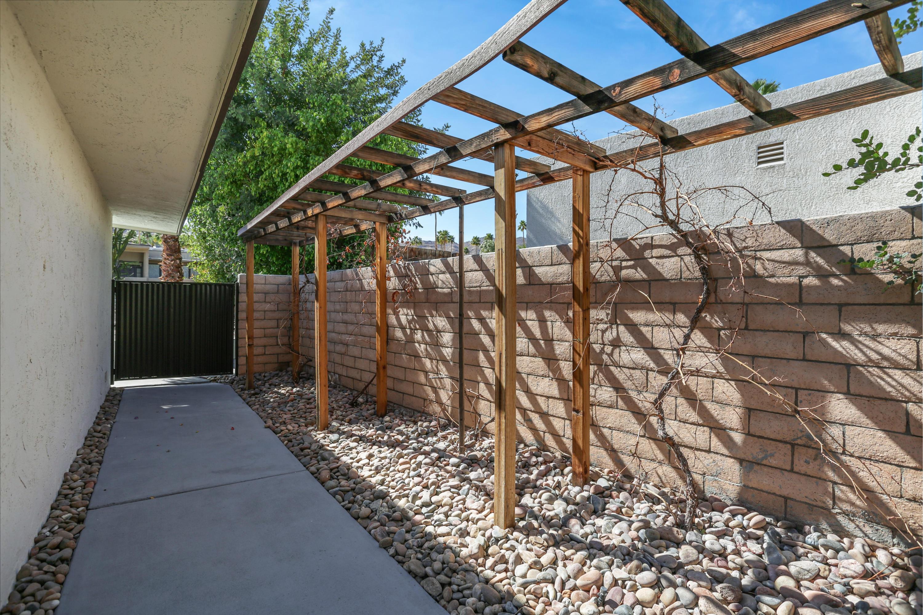 71480 Halgar Road Rancho Mirage, CA 92270 - Photo 37 of 52 a view of a pathway with a wrought fence