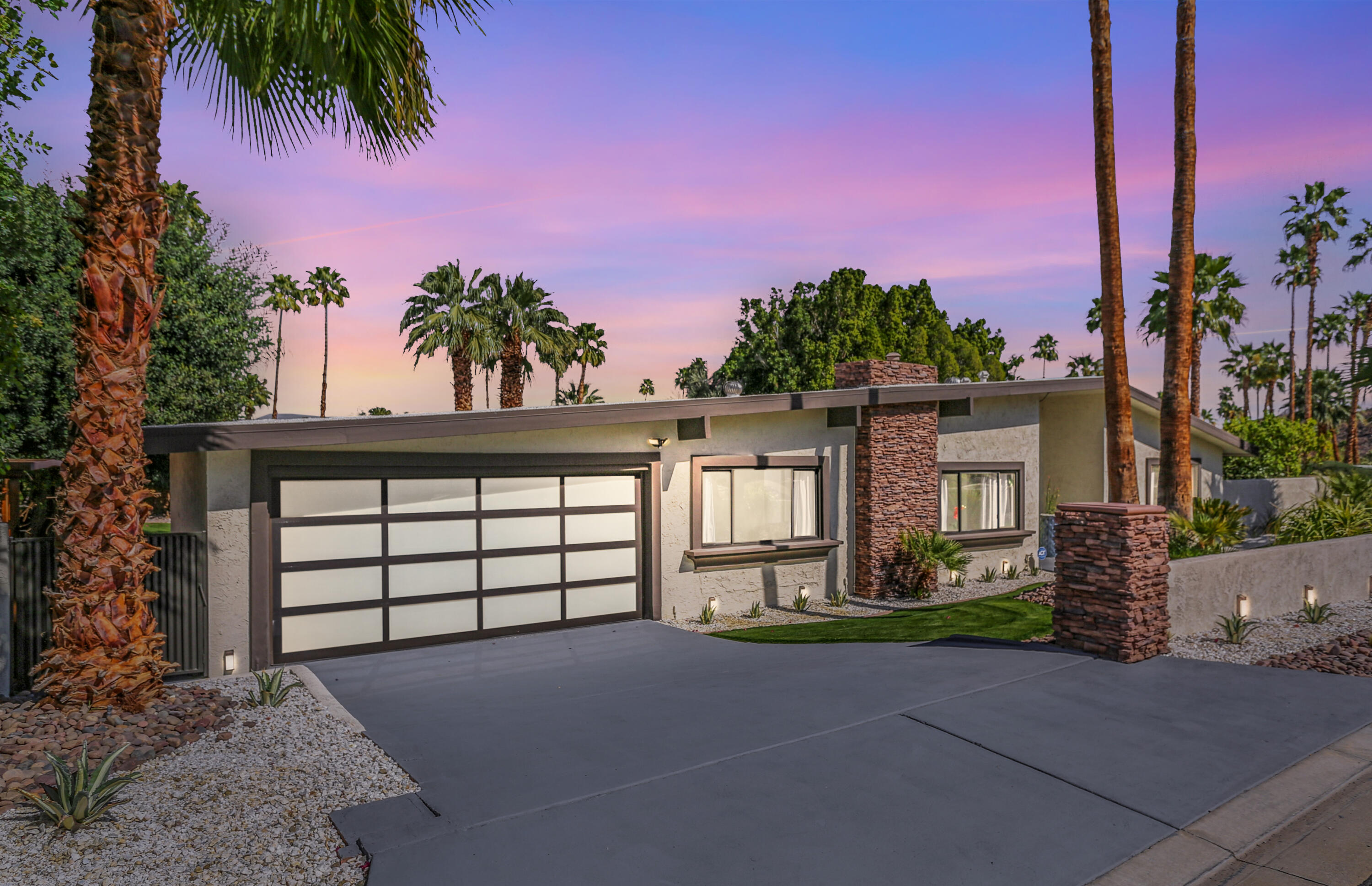 71480 Halgar Road Rancho Mirage, CA 92270 - Photo 43 of 52 a front view of a house with a yard and garage
