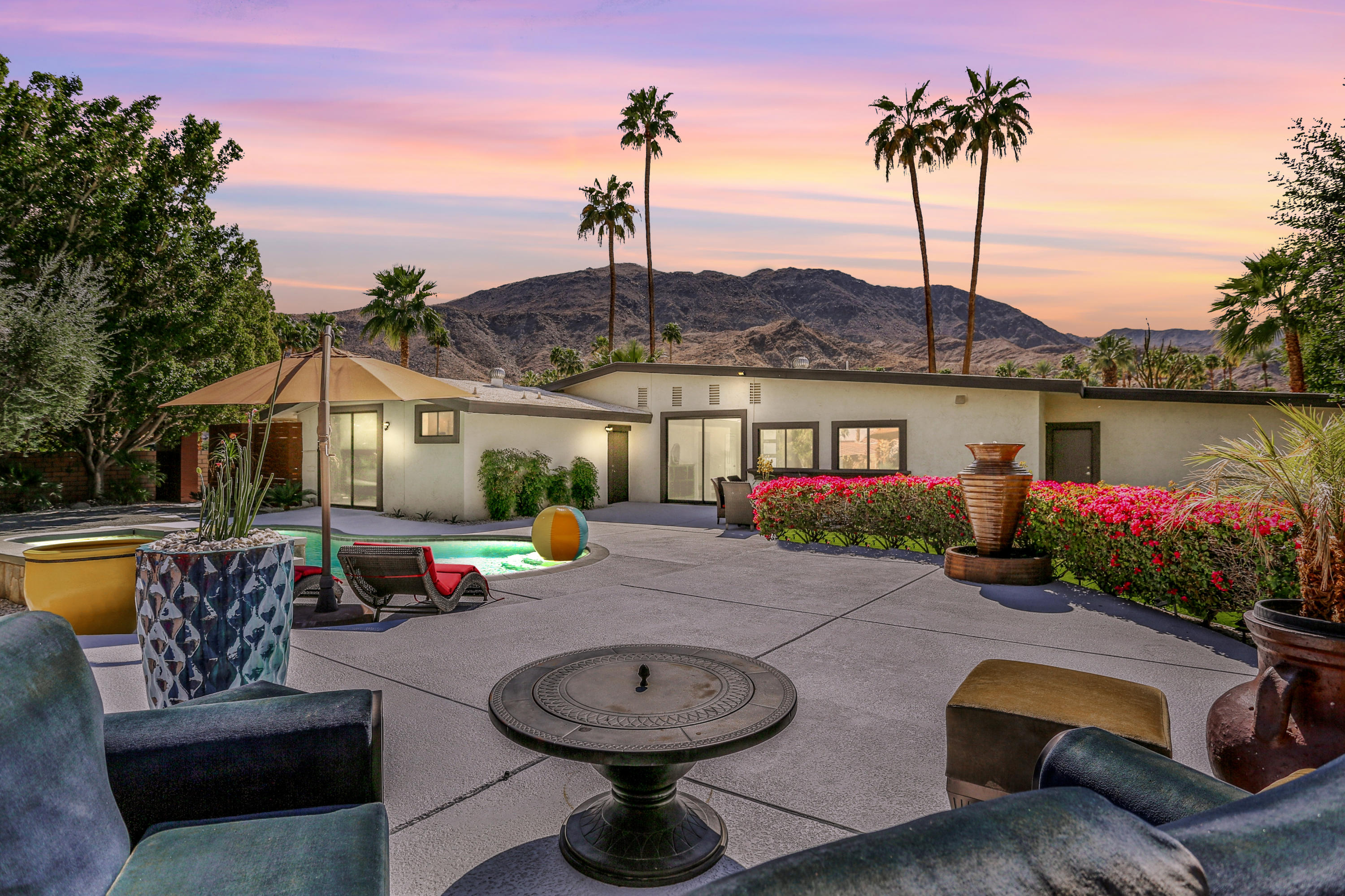 71480 Halgar Road Rancho Mirage, CA 92270 - Photo 48 of 52 a view of a patio with couches table and chairs under an umbrella