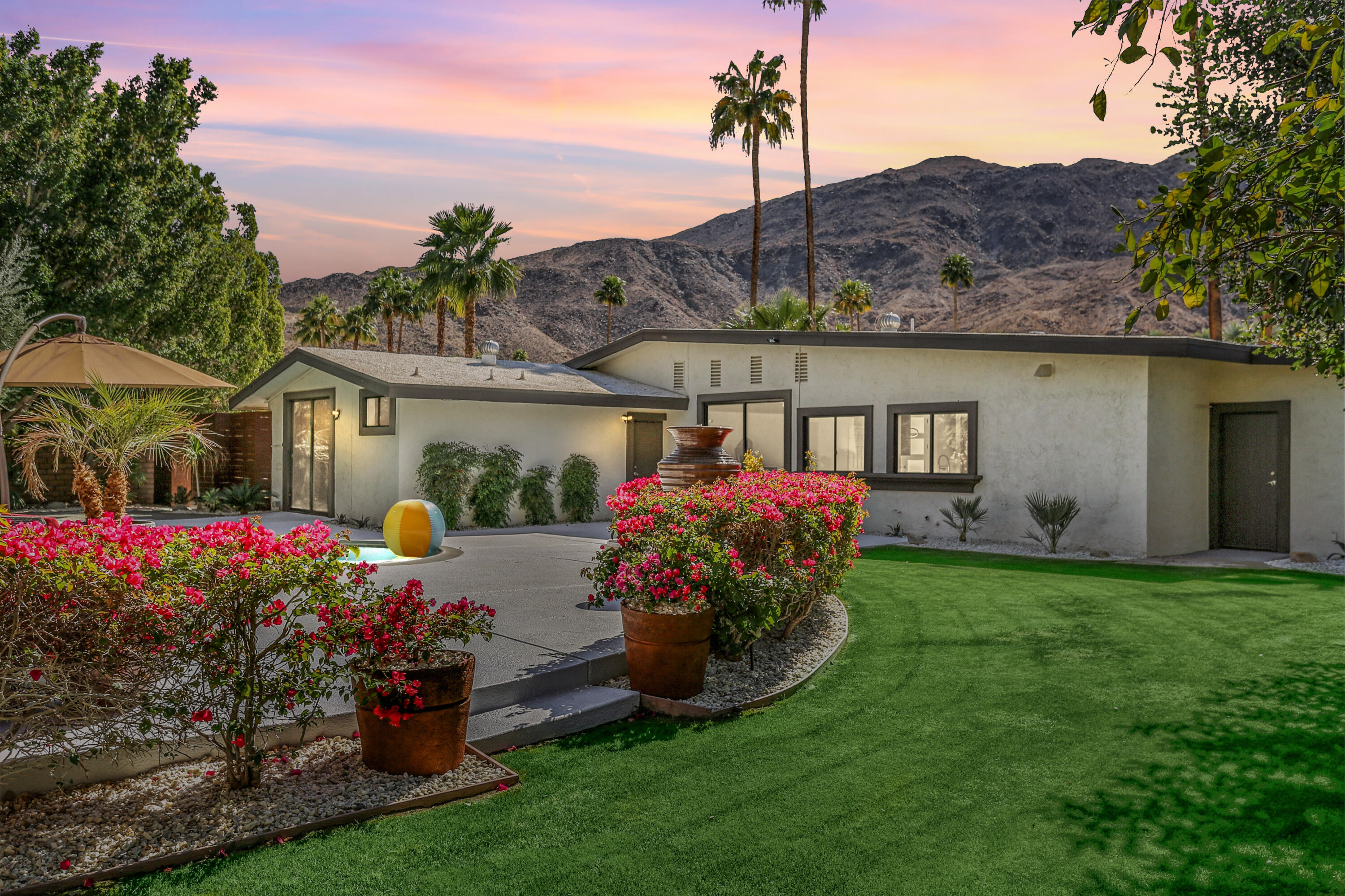 71480 Halgar Road Rancho Mirage, CA 92270 - Photo 50 of 52 a front view of a house with a yard and a garden