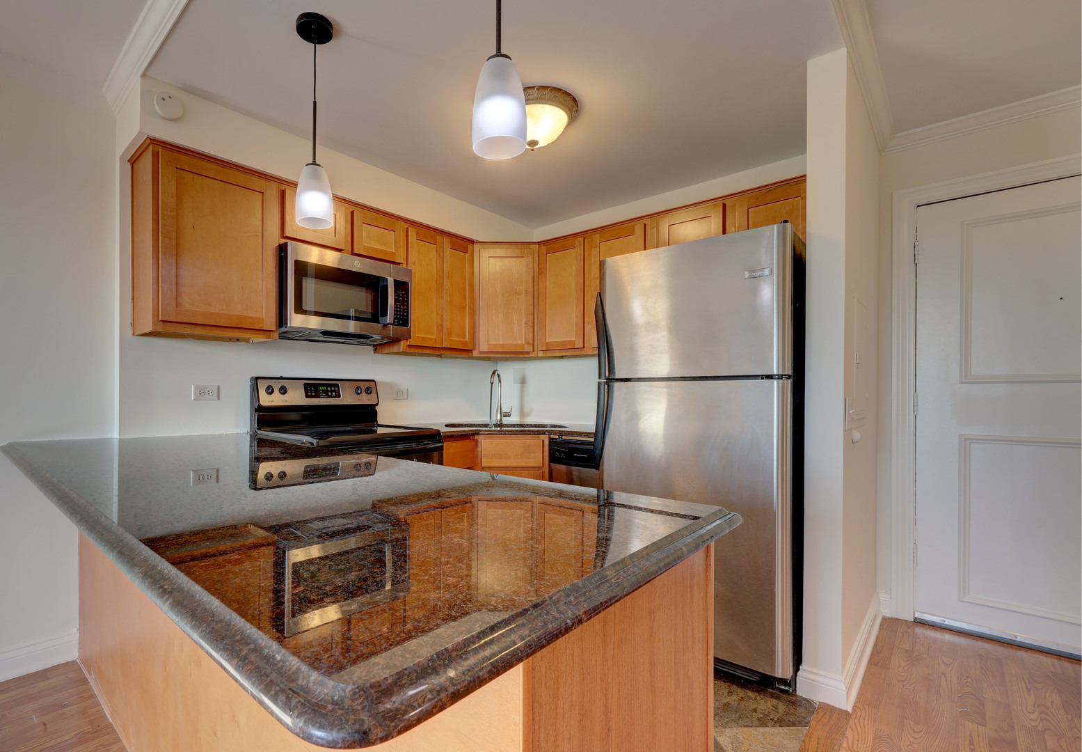 1 Renaissance Place, Unit 1212 Palatine, IL 60067 - Photo 9 of 28 a kitchen with kitchen island granite countertop a sink stainless steel appliances and counter space