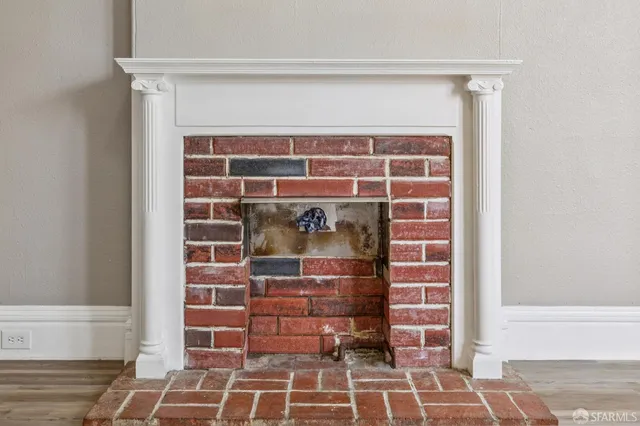 a large kitchen with stainless steel appliances granite countertop a refrigerator a sink a stove and white cabinets with wooden floor