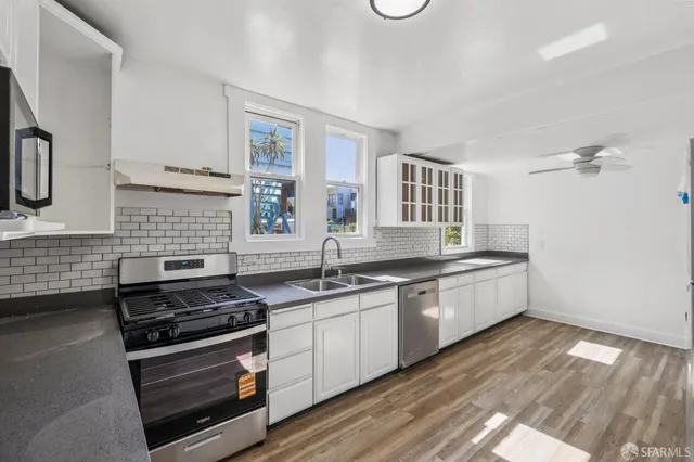 a kitchen with stainless steel appliances granite countertop lots of counter top space and cabinets