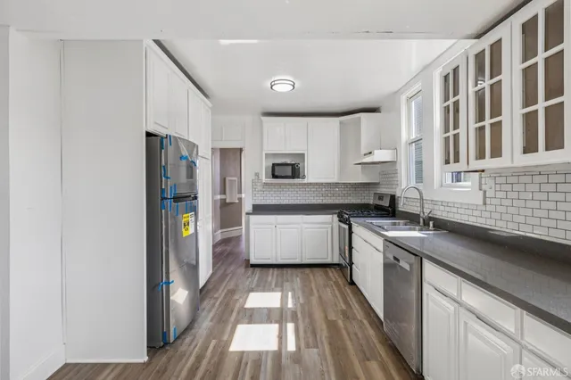 a view of an empty room and wooden floor