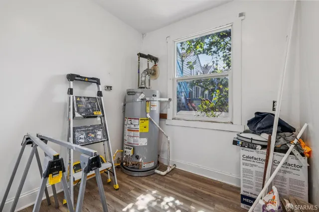 a view of an empty room with closet and a window