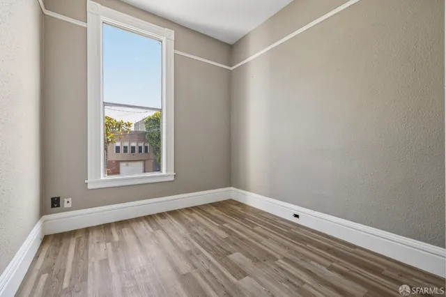 a view of balcony with wooden floor and fence