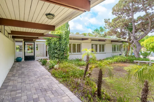 a front view of a house with garden