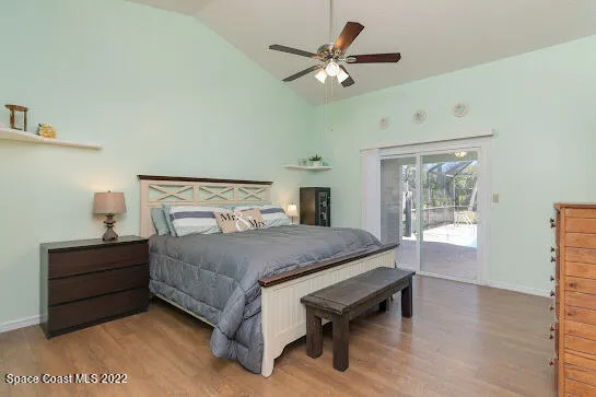 a bedroom with a bed chandelier and a window