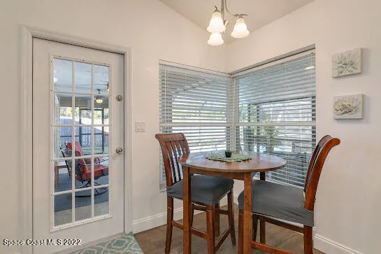 a view of a dining room with furniture and chandelier