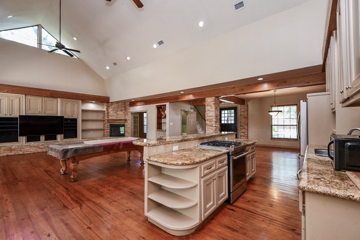 1240 Bingle Road Spring Valley Village, TX 77055 - Photo 15 of 49 a kitchen with stainless steel appliances granite countertop a stove and a wooden floors