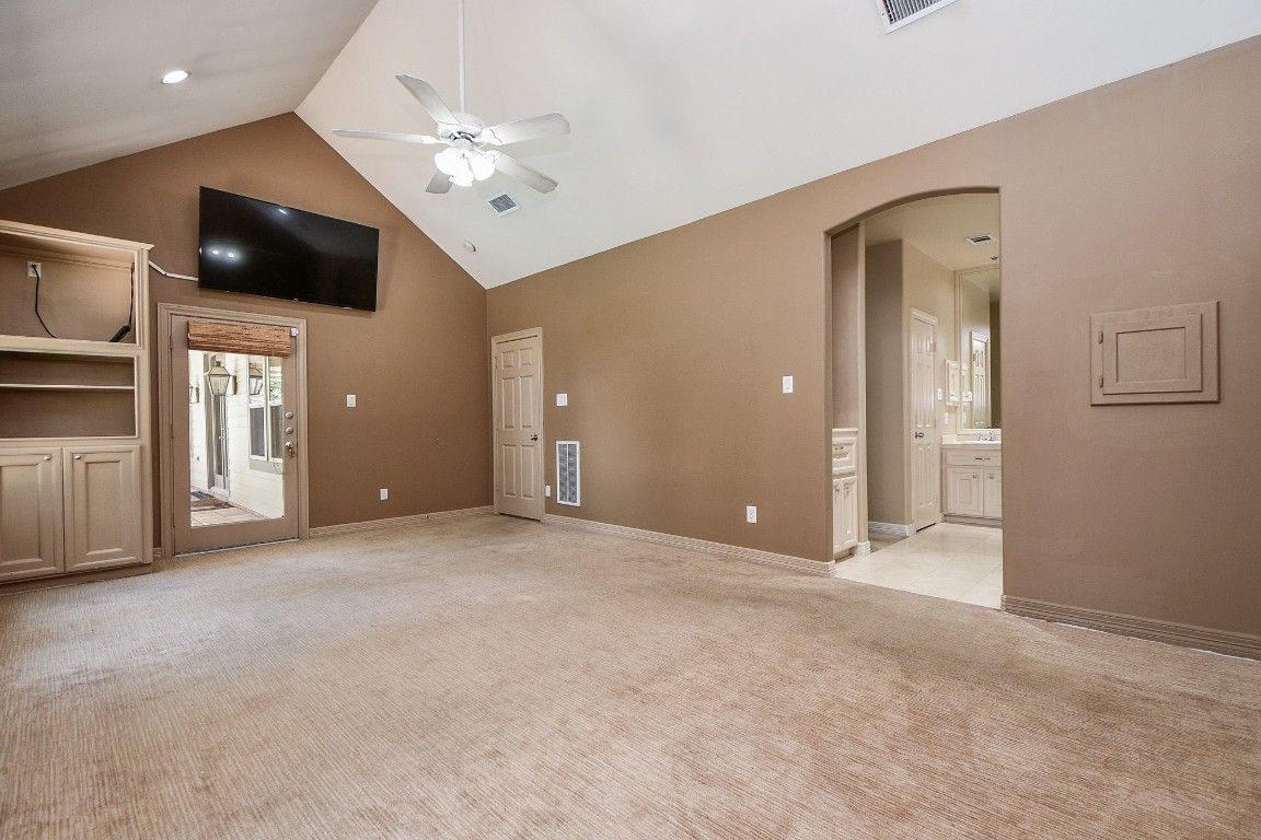 1240 Bingle Road Spring Valley Village, TX 77055 - Photo 18 of 49 This view is from the back of the primary bedroom and you can see the cabinet to the left of the picture, a private door to the back patio, and also the large television screen above the door. The opeing to the right is the entry to the primary bath