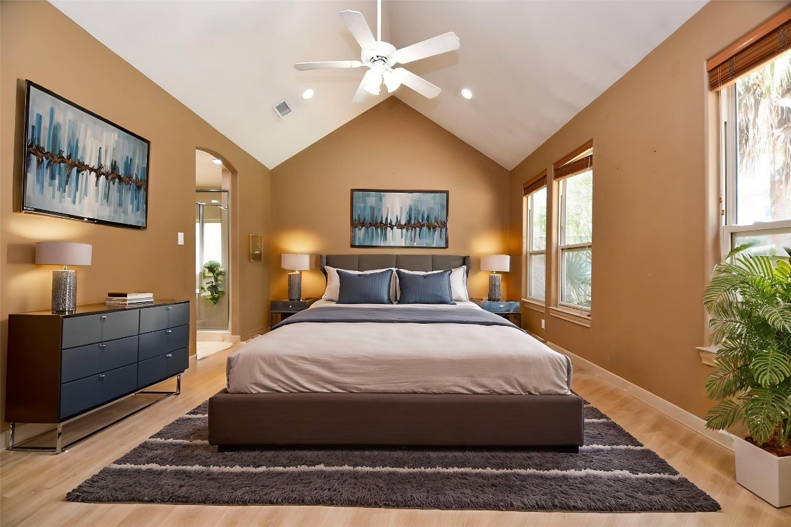 1240 Bingle Road Spring Valley Village, TX 77055 - Photo 21 of 49 a spacious bedroom with a large bed and a chandelier