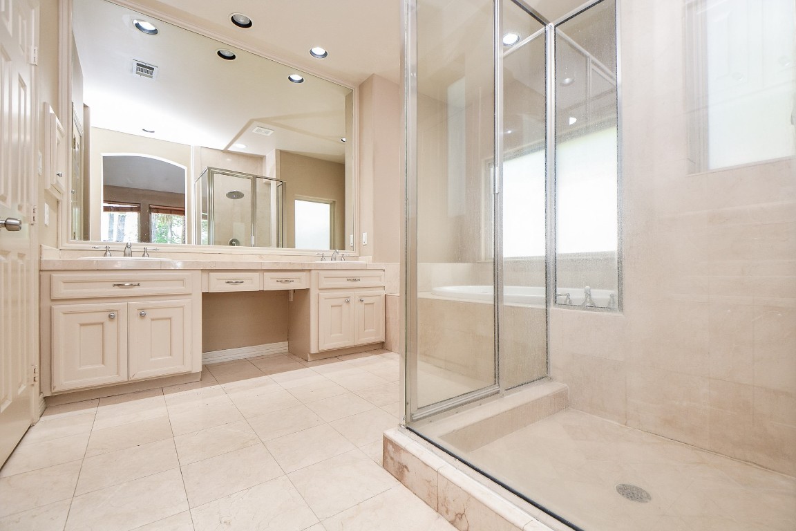 1240 Bingle Road Spring Valley Village, TX 77055 - Photo 22 of 49 As you enter the bright, roomy parimary bath you have the walkin shower to the right and double sinks with lots of counter space and a vanity area against the far wall and tub to the right