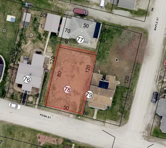 an aerial view of a house with a yard and parking