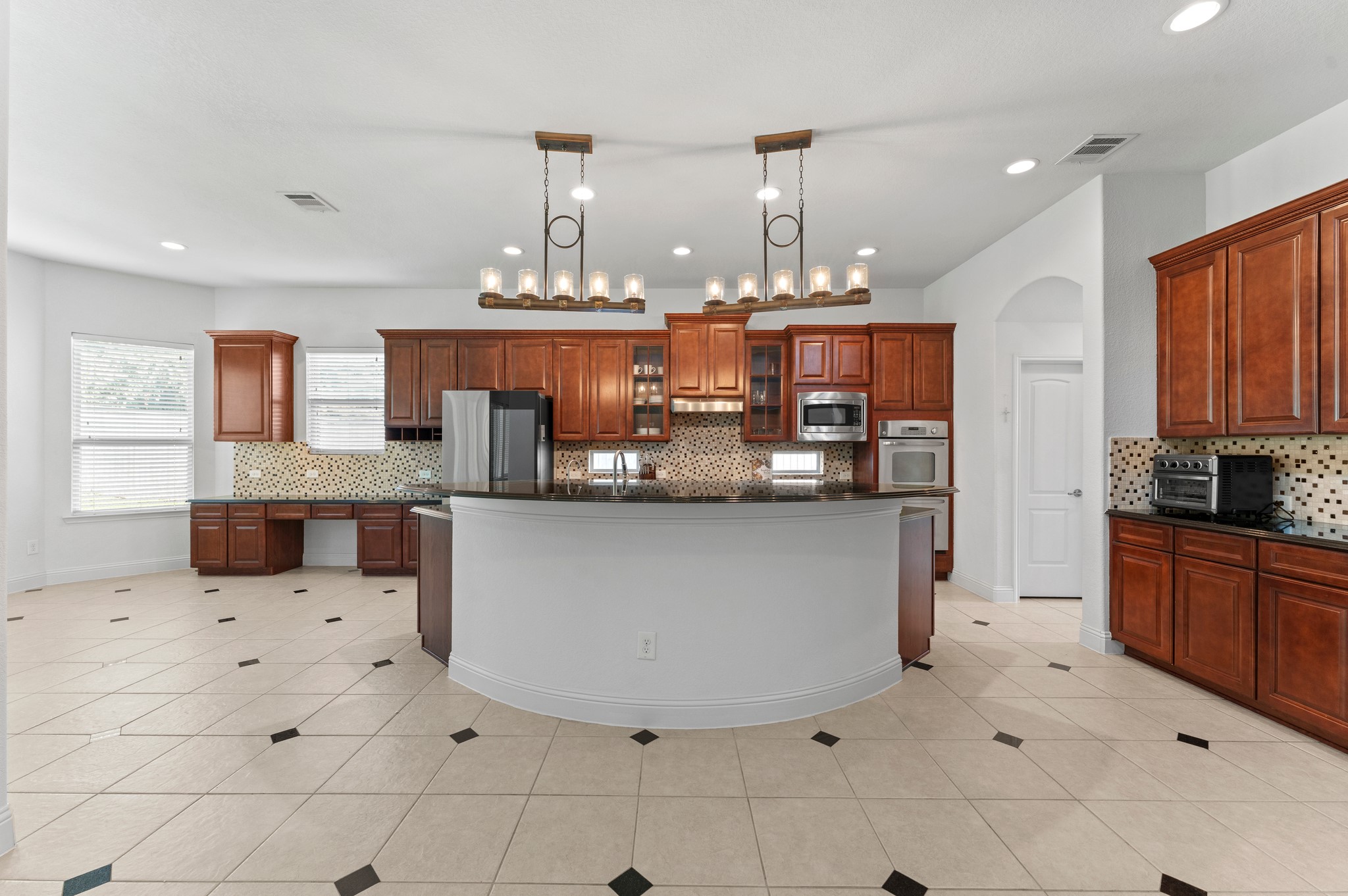 39 Tioga Place Tomball, TX 77375 - Photo 18 of 49 a kitchen with stainless steel appliances kitchen island granite countertop a sink and cabinets