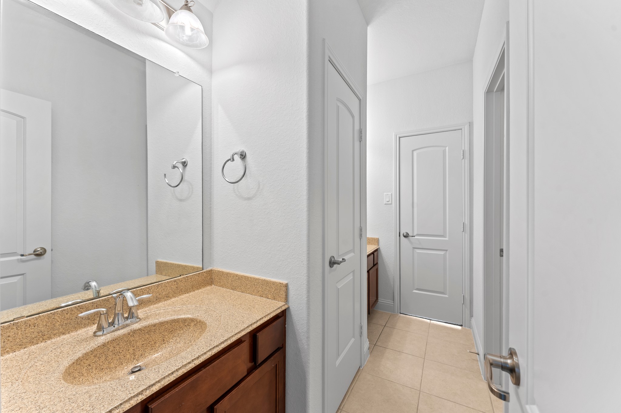 39 Tioga Place Tomball, TX 77375 - Photo 36 of 49 a bathroom with a sink vanity and a mirror