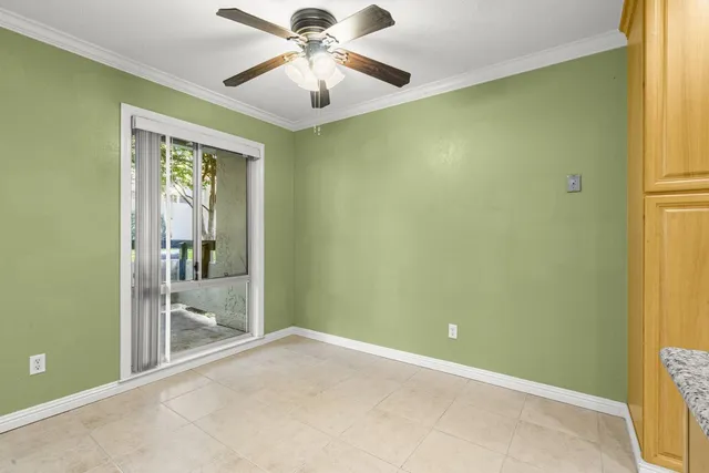 an empty room with a ceiling fan and a window