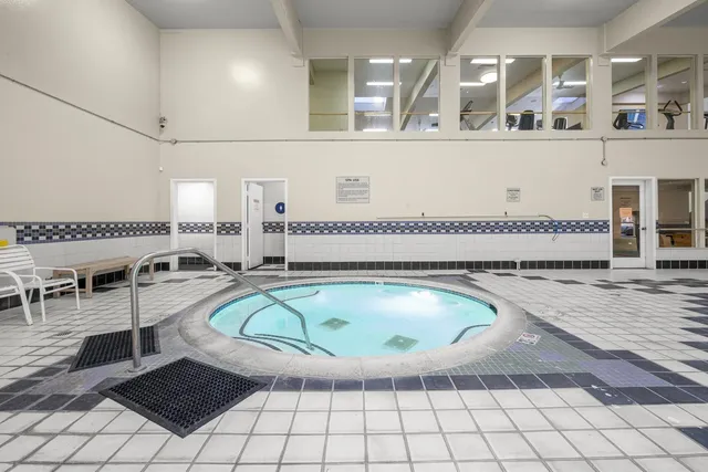 a view of a swimming pool and lounge chair