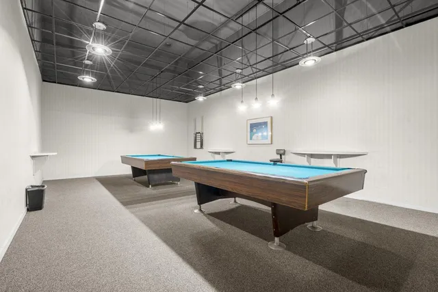 a room with pool table and furniture