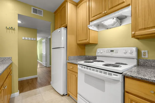 a kitchen with a stove and a refrigerator