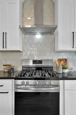 a close view of a stove a microwave and cabinets