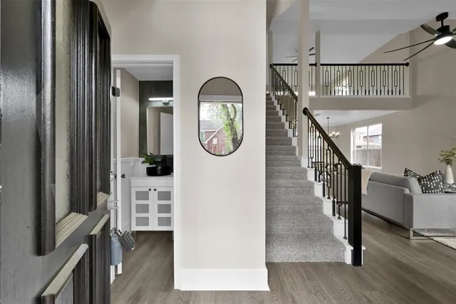 a view of a livingroom with furniture entryway wooden floor and front door